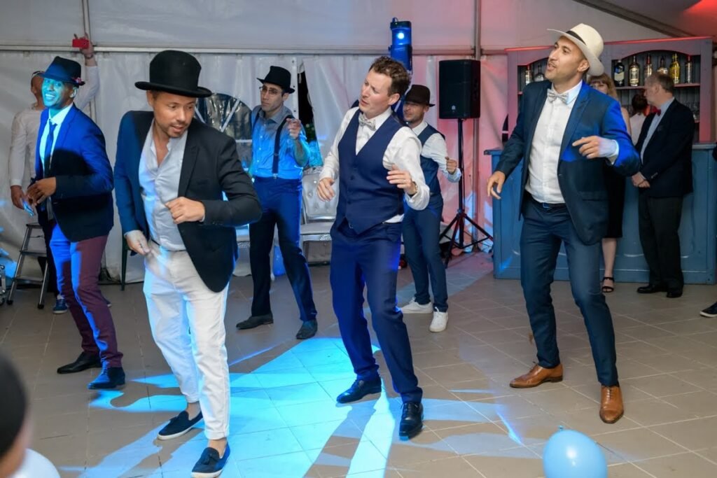 Friends posing together after a stag party dance class in Barcelona - smiling group photo at the wedding