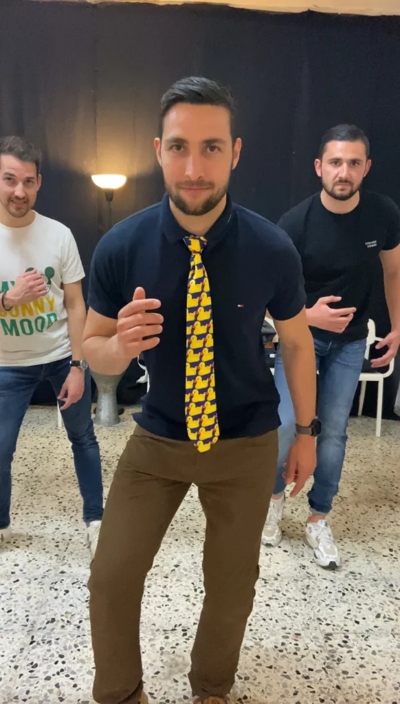 Group of friends learning salsa steps during a stag party in Barcelona - private class in a Born district studio